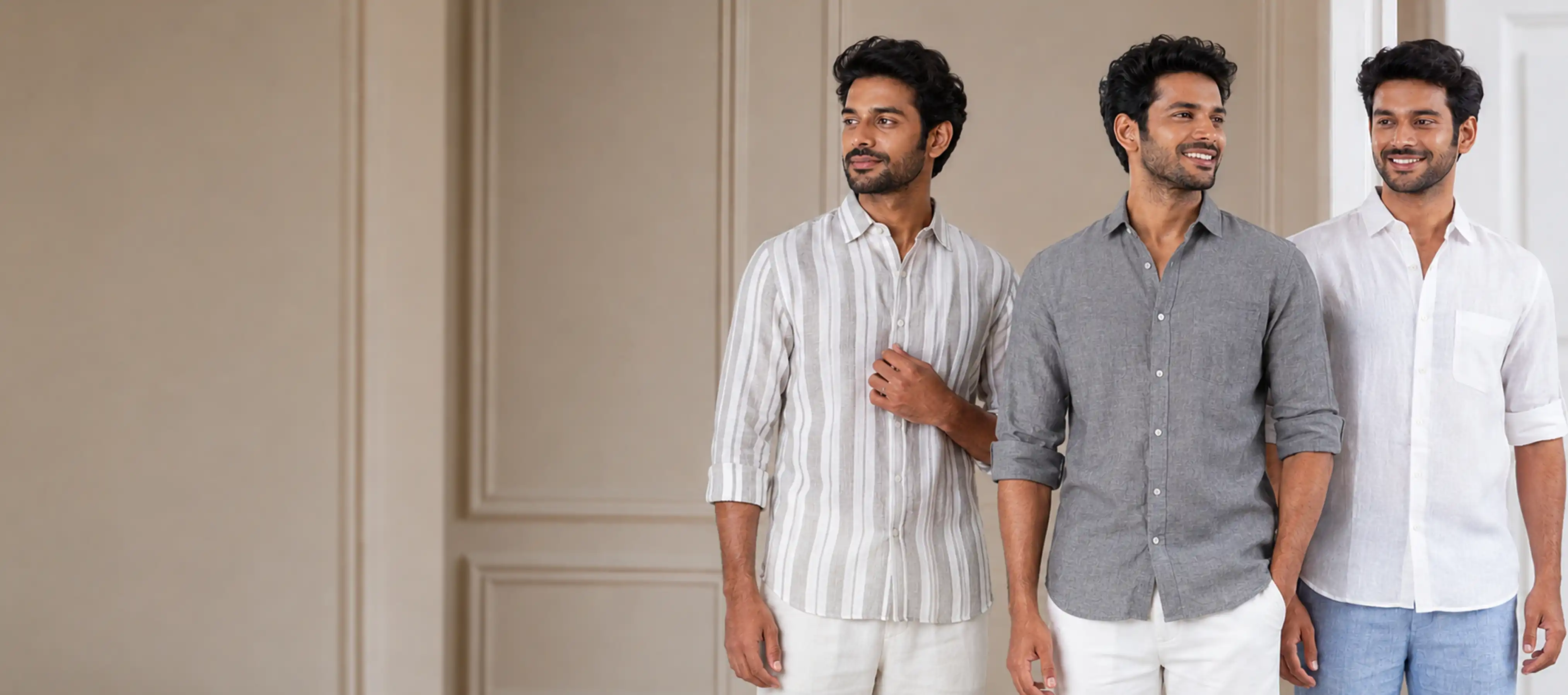 Three men in linen shirts — striped, grey and white — against a warm panelled wall